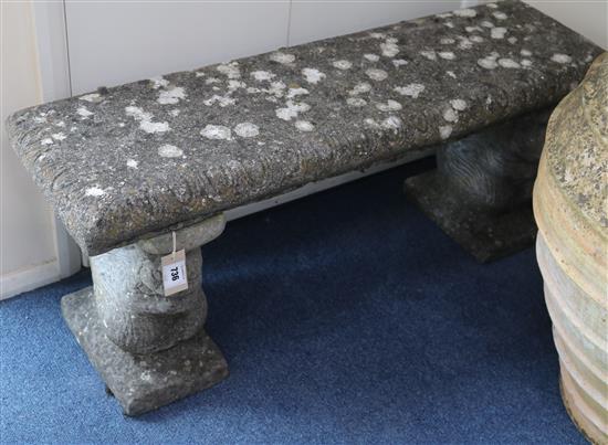 A stone garden bench, W.105cm
